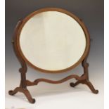 Early 20th Century mahogany framed swing dressing mirror with oval plate on shaped supports