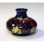 Small Moorcroft squat baluster vase decorated with the Pansy pattern on a blue ground Condition: