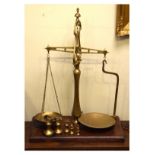 Set of large Librasco brass beam scales with weights, standing on a rectangular mahogany base