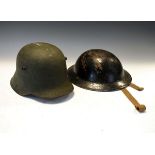 Militaria - World War II German helmet, together with a similar British helmet Condition: