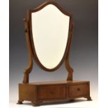 Early 20th Century mahogany shield shaped swing dressing mirror, the serpentine base fitted two