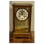 Late 19th/early 20th Century French brass cased four glass mantel clock, the white enamel dial