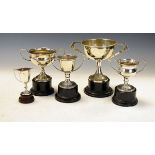 Small silver two handled trophy cup, 1.1oz approx, together with four silver plated trophy cups
