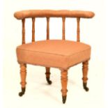 Late Victorian tub library chair with ring turned fruitwood supports and four tapering legs with