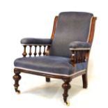 Victorian walnut framed easy chair having an over stuffed back between moulded uprights, the plain