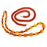 Amber bead necklace, together with a coral necklace Condition: