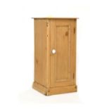 Pine bedside cabinet with single door enclosing shelf on plinth base Condition: