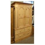 20th Century pine two stage linen press having a pair of arched panelled doors enclosing brass