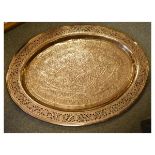 Large Eastern copper charger of oval form with pierced border, 67cm x 99cm Condition: