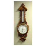 Late Victorian/Edwardian oak cased aneroid barometer with white dial reading from 26 to 31 inches of