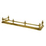 Brass fender having six urn finials connected by tubular rails Condition: