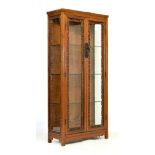 Modern Chinese hardwood framed display cabinet, the glazed doors and side panels with fret-work