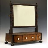 Early 19th Century mahogany swing dressing mirror, the plain rectangular plate in real carved