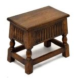 Reproduction oak box/stool having a hinged cover and standing on turned supports united by