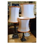 Two silver plated Corinthian column table lamps, together with a third white painted metal lamp