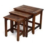Nest of three hardwood occasional tables of 'luggage rack' design with slatted rectangular tops