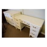 Cream painted French style bedroom chest of three drawers, together with a matching kneehole