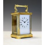 Early 20th Century French brass cased carriage clock, the white enamel dial with Roman numerals,
