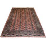 20th Century Middle Eastern wool rug, the brick red field decorated with four rows of eighteen guls