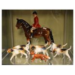 Mid 20th Century group of hunting figures comprising: huntsman on horse and six hounds, together
