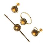 Yellow metal ring set citrine within a decorative surround, size R, a matching bar brooch stamped