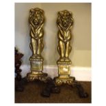 Pair of cast brass andiron front supports, each formed as a seated lion Condition: