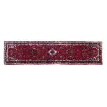 Good quality modern Persian runner, typically decorated with stylised foliage on a red ground within