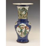 Large Chinese Famille Verte baluster shaped vase decorated with shaped reserves depicting