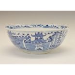 Chinese porcelain bowl having blue and white painted decoration depicting a fort and buildings in