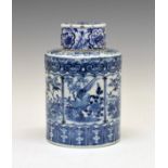 Chinese porcelain cylindrical jar and cover having blue and white painted reserve panels, each