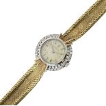 Corum - Lady's 9ct gold diamond set bracelet watch, the circular textured dial with steel coloured