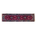 Good quality modern Turkish Doshe wool runner having typical geometric decoration on a red ground