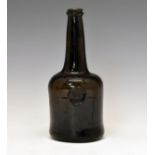 Mid 18th Century green glass wine bottle bearing a circular seal with the initials W.H. and date