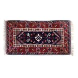 Good quality modern Turkish wool rug having typical geometric decoration on a blue ground within