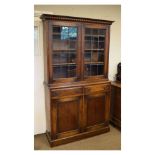Early 20th Century oak bookcase on cabinet, the upper stage with moulded cornice over leaded tracery