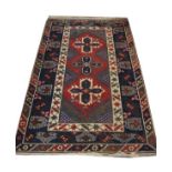Middle Eastern wool rug, the crimson field with three cruciform medallions within multi borders,