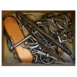 Selection of horse tack to include: bits, stirrups, spurs, brush named 'Horsey' beneath, leather