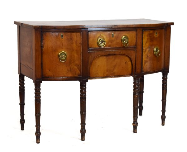 Early 19th Century mahogany bow breakfront sideboard with central frieze drawer and kneehole moulded