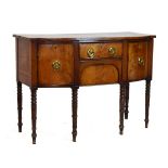 Early 19th Century mahogany bow breakfront sideboard with central frieze drawer and kneehole moulded