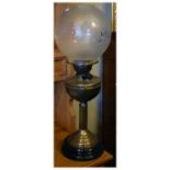 Early 20th Century brass column paraffin lamp with frosted glass spherical shade over twin burner on