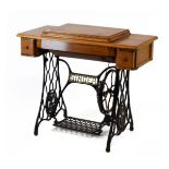 Oak cased Singer sewing machine on iron treadle base Condition: