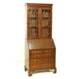 Early 20th Century mahogany bureau bookcase, the upper stage with dentil cornice over glazed tracery