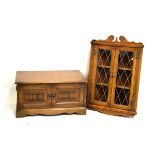 Reproduction oak corner cupboard with leaded tracery glazed doors enclosing two shelves, together