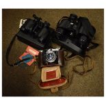 Two cased pairs of binoculars/field glasses and a camera comprising: Tecnar 8 x 30 wide angle