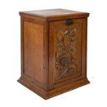 Interesting early 20th Century carved oak purdonium, the hinged fall front carved with sunflowers (