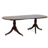Reproduction mahogany Georgian design twin pillar dining table fitted one insertion, raised on