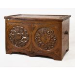 Early 20th Century carved oak coffer, the hinged cover with acanthus decoration above a carved front