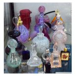 Collection of various glass table scent bottles, atomisers, two cranberry glass jugs etc Condition: