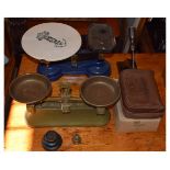 Two pairs of early 20th Century grocer's cast iron scales, the first blue painted stamped