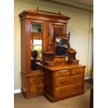 Early 20th Century walnut combination wardrobe, the moulded cornice over bevelled mirrored door